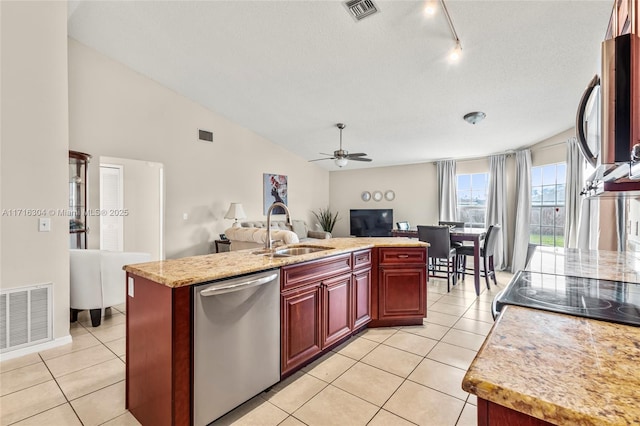 kitchen featuring ceiling fan, a kitchen island with sink, sink, light tile patterned floors, and dishwasher