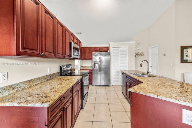 kitchen with light stone counters, sink, light tile patterned flooring, and appliances with stainless steel finishes