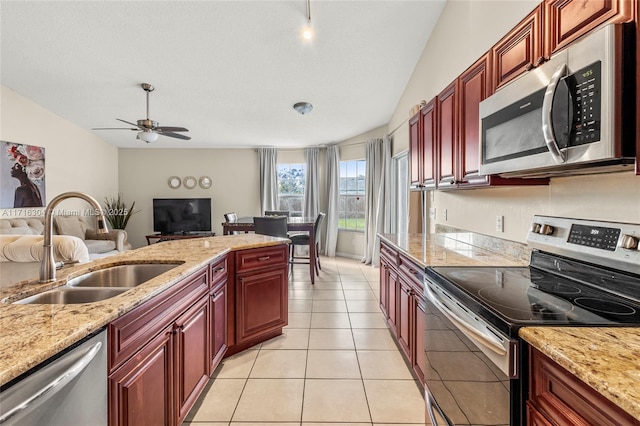 kitchen with lofted ceiling, sink, ceiling fan, light tile patterned floors, and appliances with stainless steel finishes