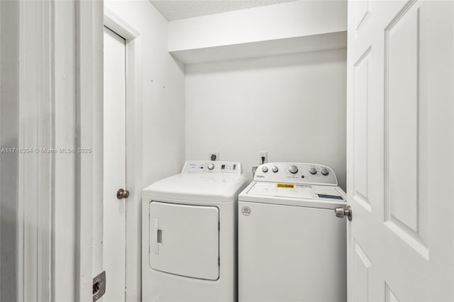 laundry area featuring independent washer and dryer and a textured ceiling