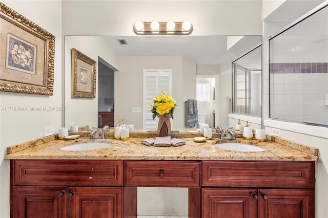 bathroom featuring vanity and a shower with shower door