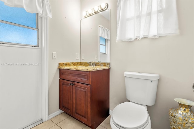 bathroom featuring toilet, vanity, and tile patterned floors