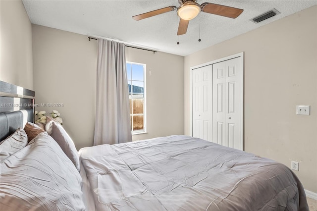 bedroom with a textured ceiling, a closet, and ceiling fan