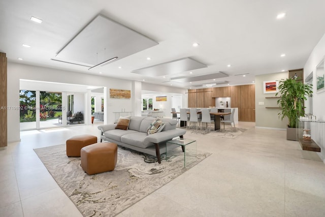 living room featuring a raised ceiling