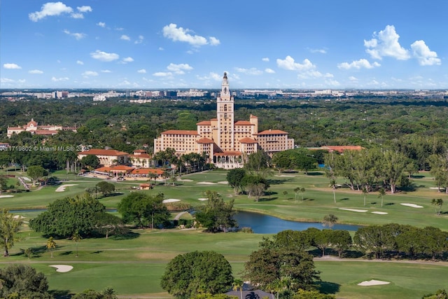 drone / aerial view featuring view of golf course and a water view