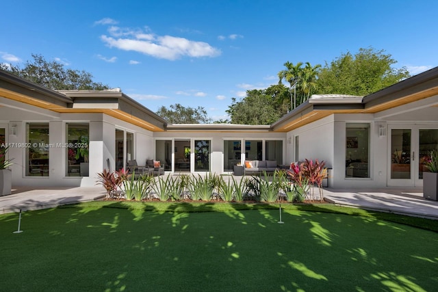 4144 Pinta Ct, Coral Gables, FL 33146 - back of property with stucco siding, a patio, and an outdoor hangout area