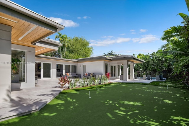 4144 Pinta Ct, Coral Gables, FL 33146 - rear view of house with stucco siding and a patio