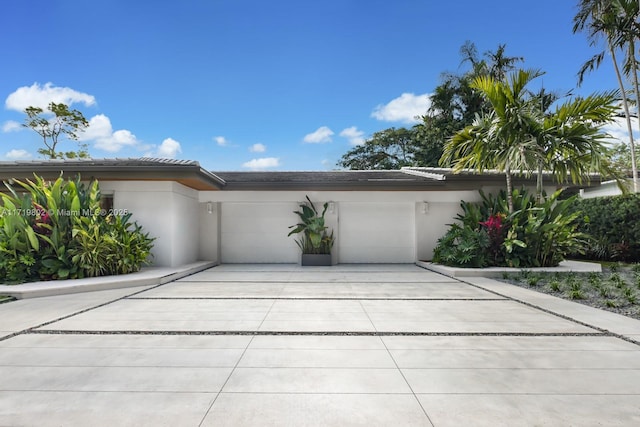 4144 Pinta Ct, Coral Gables, FL 33146 - view of front of house with a garage, concrete driveway, a tiled roof, and stucco siding