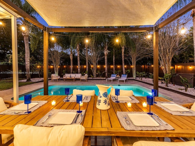 view of pool with a wooden deck, an outdoor hangout area, and a patio