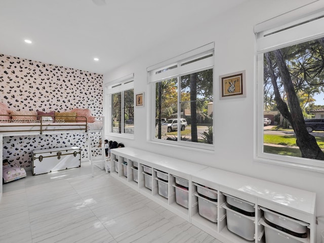 bedroom featuring recessed lighting and marble finish floor