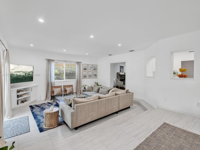 living area with recessed lighting and baseboards