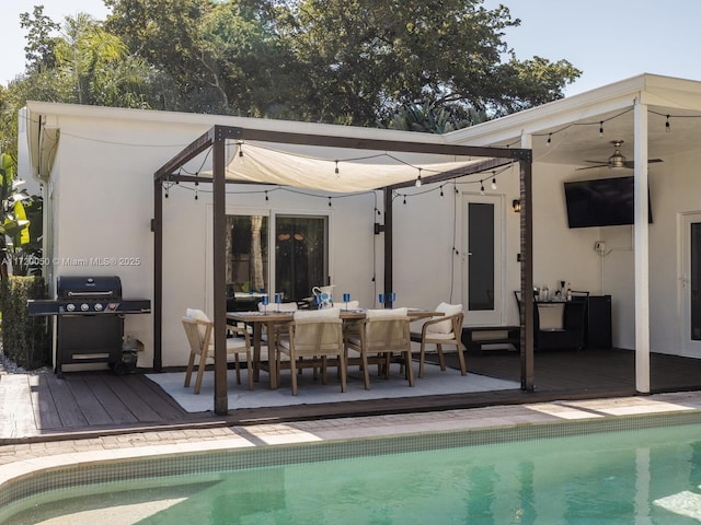 exterior space with a deck, outdoor dining space, an outdoor pool, and stucco siding