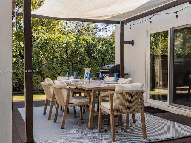 view of patio with area for grilling and outdoor dining space