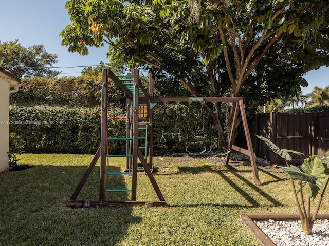 view of playground featuring a yard and a fenced backyard