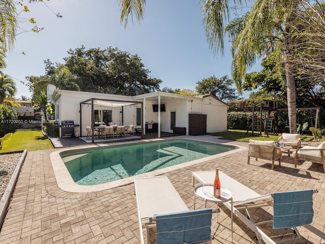 outdoor pool featuring a patio area, an outdoor hangout area, and fence