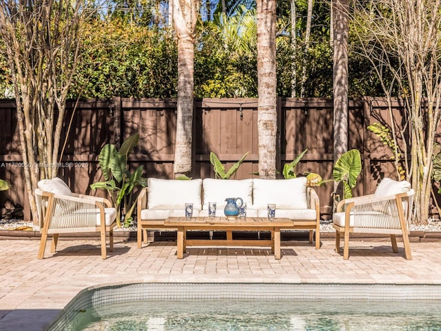 view of patio with a fenced in pool, outdoor lounge area, and a fenced backyard