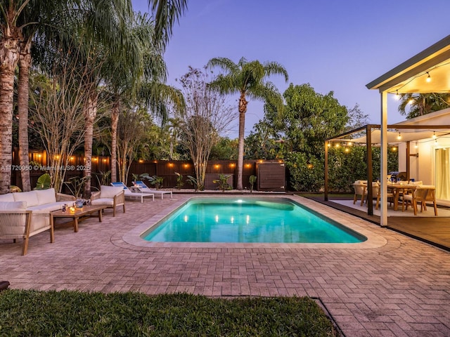 view of pool featuring an outdoor living space, a fenced in pool, a patio, and a fenced backyard