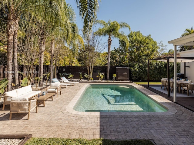 view of pool featuring a patio area, a fenced in pool, outdoor lounge area, and a fenced backyard