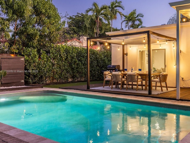 view of pool with a fenced in pool, a wooden deck, and a fenced backyard