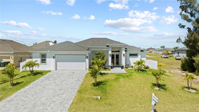 view of front of house with a front yard and a garage