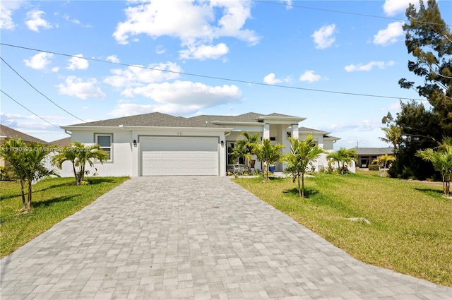 view of front of property featuring a garage and a front lawn