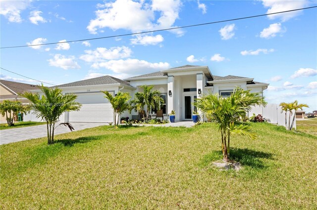 view of front of property with a front yard and a garage