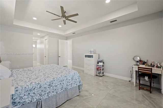 bedroom with a tray ceiling and ceiling fan