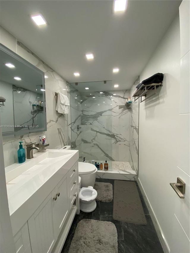 bathroom featuring vanity, toilet, and a tile shower