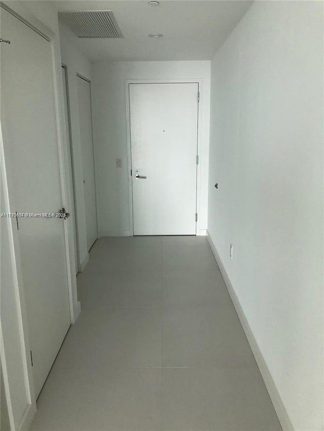 corridor with light tile patterned flooring