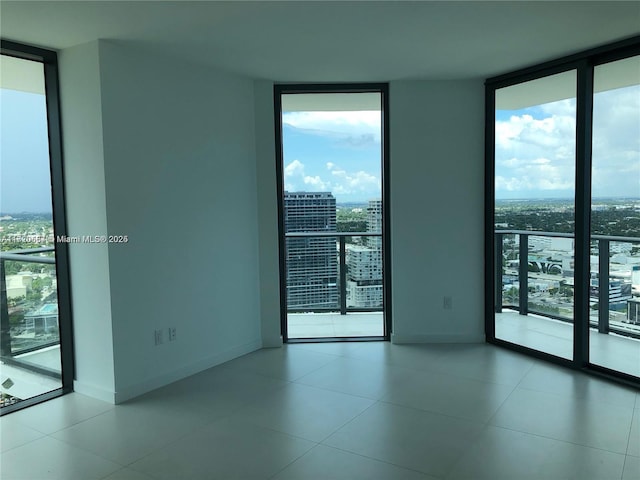 spare room with floor to ceiling windows