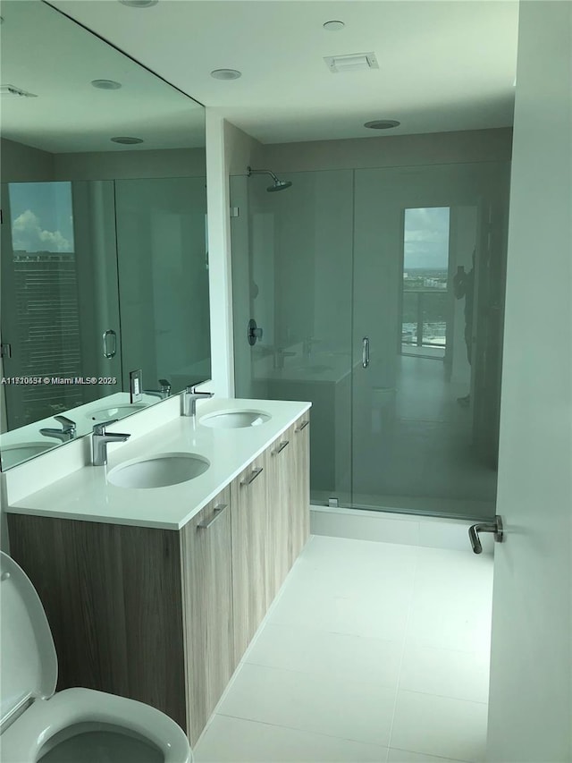 bathroom featuring vanity, toilet, and an enclosed shower