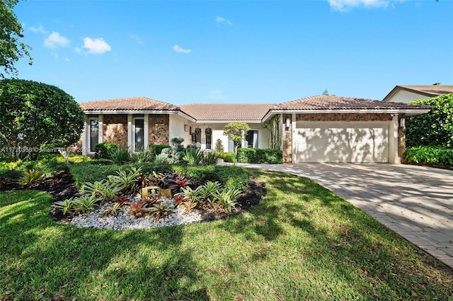 mediterranean / spanish house featuring a front yard and a garage