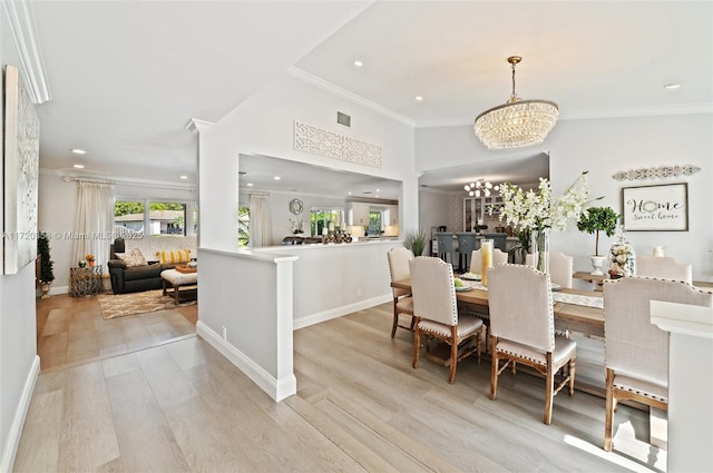 dining area featuring light hardwood / wood-style flooring, an inviting chandelier, and ornamental molding