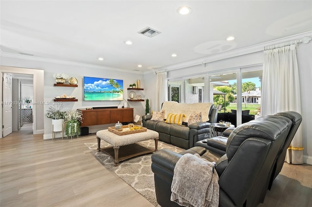 living room featuring light hardwood / wood-style floors and crown molding