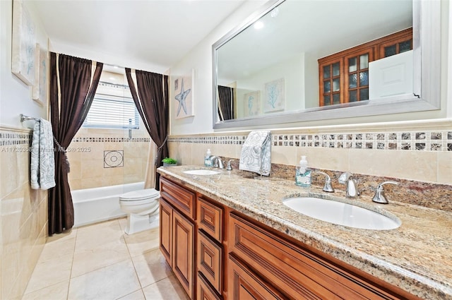 full bathroom featuring shower / bath combo, tile patterned floors, vanity, tile walls, and toilet