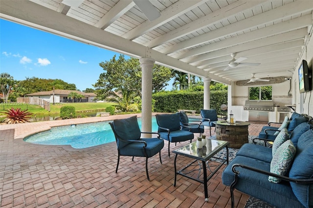 view of patio with an outdoor kitchen, an outdoor hangout area, area for grilling, ceiling fan, and a fenced in pool