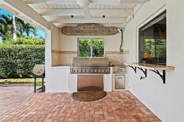 view of patio / terrace with an outdoor kitchen, grilling area, and ceiling fan