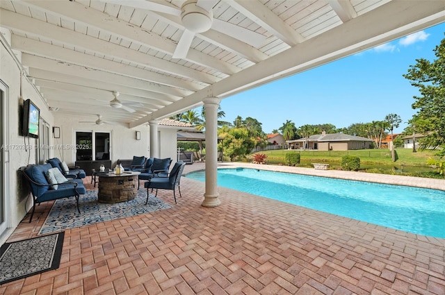 view of pool featuring a patio, an outdoor living space with a fire pit, and ceiling fan