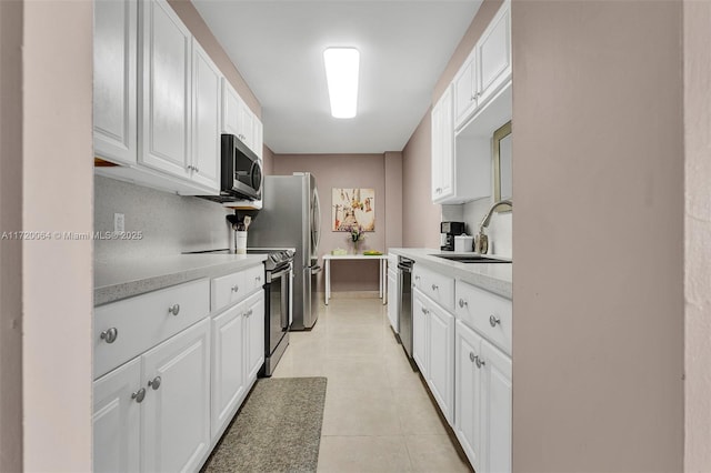 kitchen featuring white cabinetry, sink, and stainless steel appliances