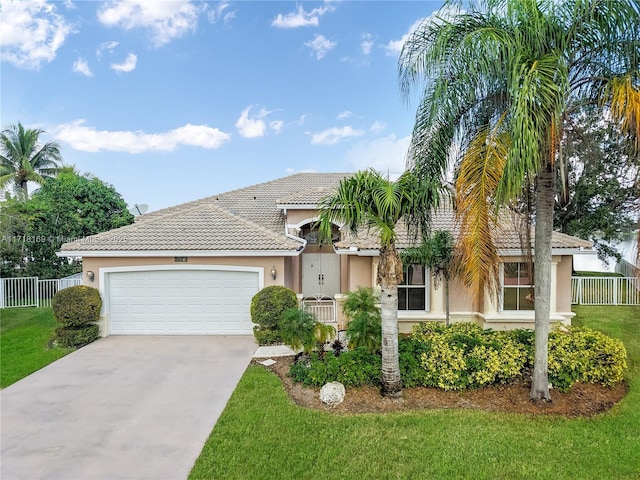 view of front of home featuring a front yard and a garage