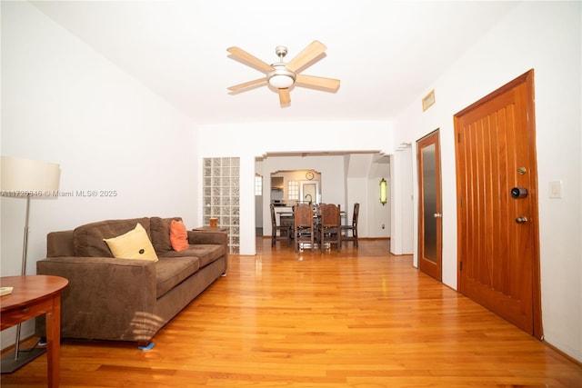 living room with ceiling fan and light hardwood / wood-style floors