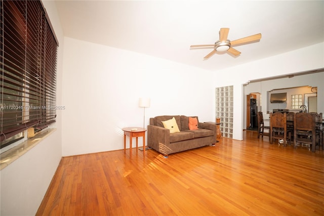 living room featuring hardwood / wood-style floors and ceiling fan