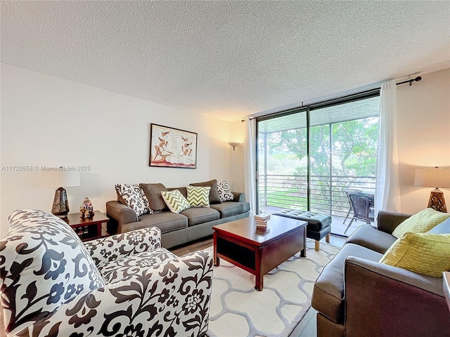 living room featuring a textured ceiling and a wall of windows