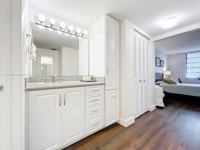 bathroom featuring plenty of natural light, vanity, and hardwood / wood-style flooring