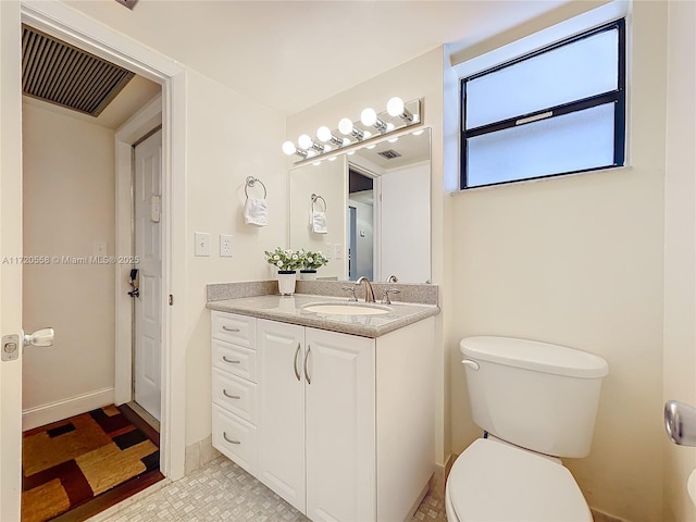 bathroom featuring vanity and toilet