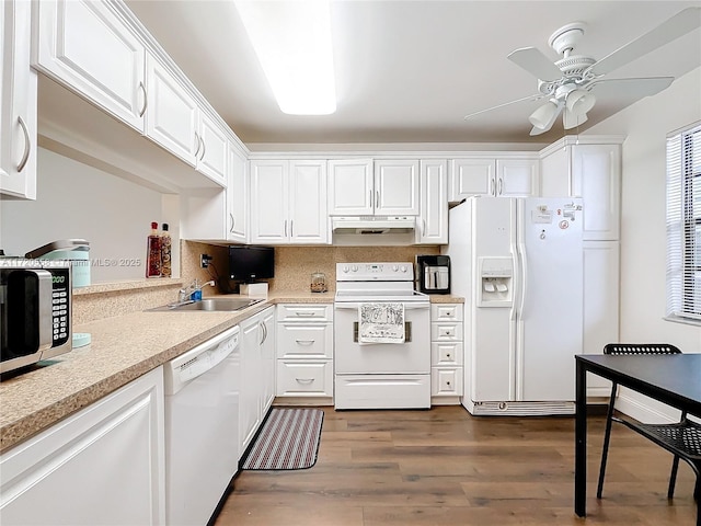 kitchen with white appliances, white cabinets, sink, ceiling fan, and dark hardwood / wood-style flooring