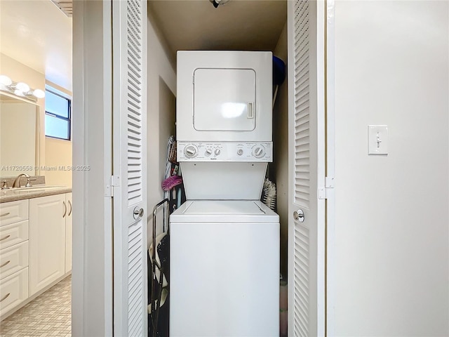 washroom with sink and stacked washer and dryer