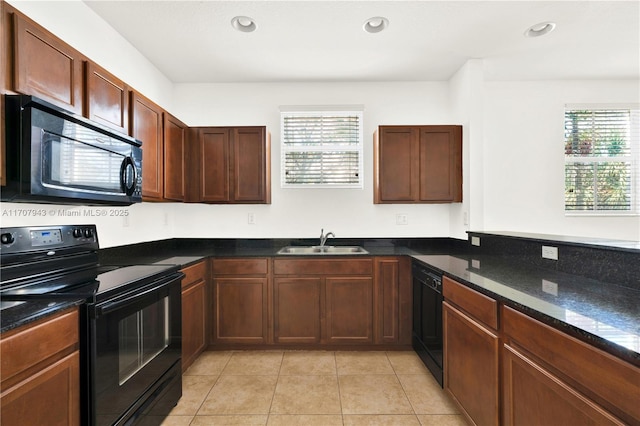 kitchen with a healthy amount of sunlight, sink, light tile patterned floors, and black appliances