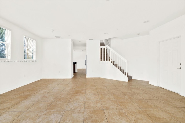 spare room featuring light tile patterned floors