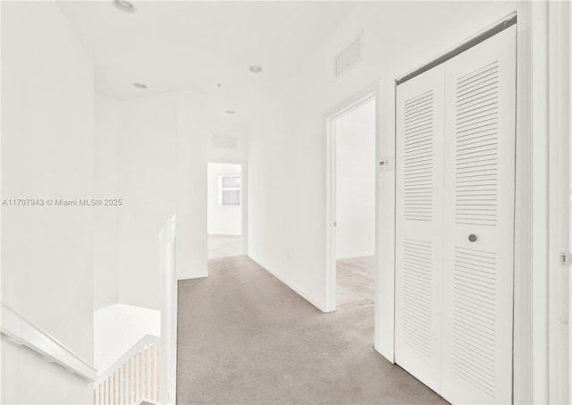 hallway with light colored carpet